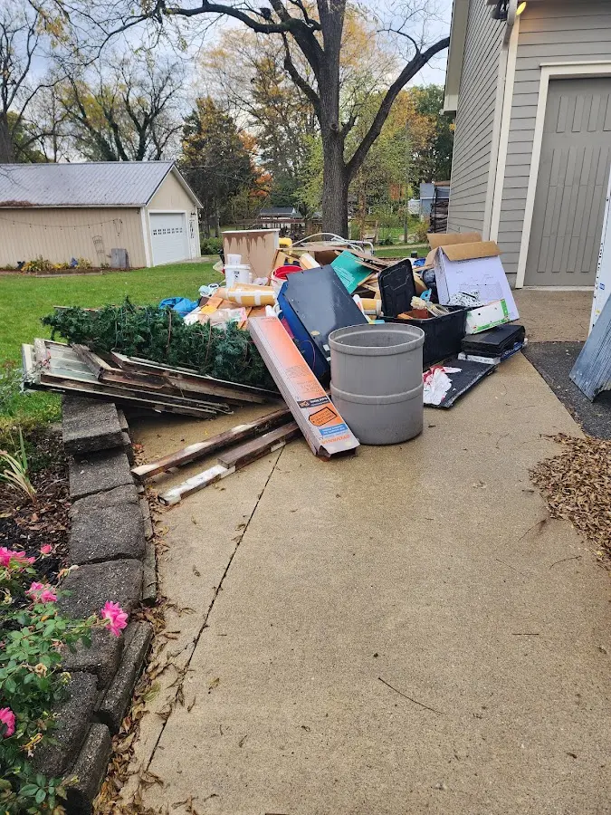 Dumpster being loaded with debris for Estate Cleanout Dumpster Rental in Gloucester